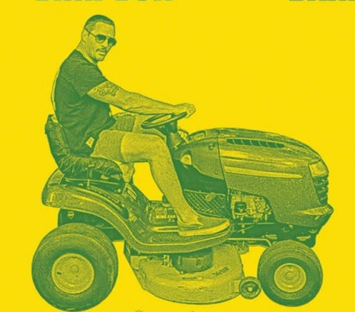a man on a lawn mower being driven by an engine