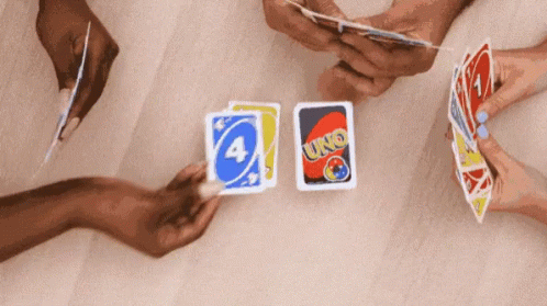 three people hands holding cards from four sides of the screen