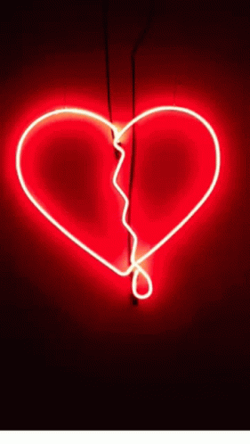 a blue neon light heart shaped by a cord