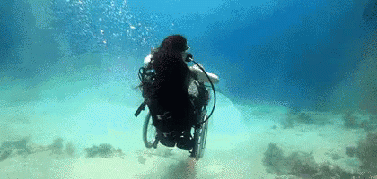 a person on a wheel chair in the water