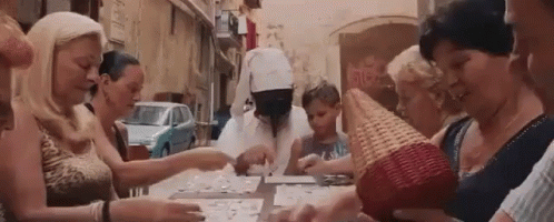 group of girls dressed in white making crafts outside