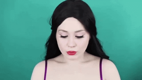 a woman wearing makeup that looks like her head is almost in a po