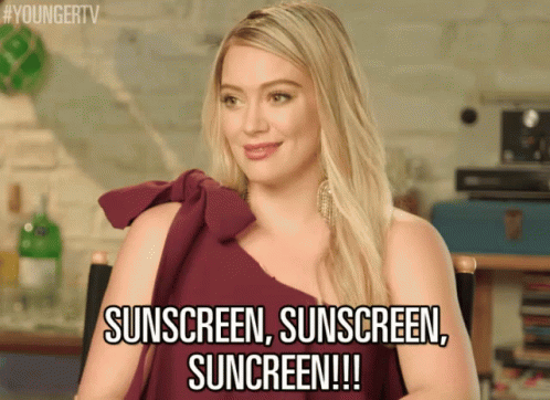 a woman with a purple top that reads,'sun screen, sunscreen, suncren screen '