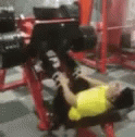 a woman laying on the floor as she does bench presses