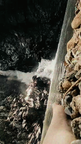 the view from above a mountain shows rough flowing water
