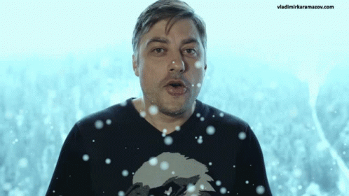a man with his mouth open is in front of a background of snow