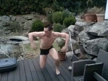 a man is standing on the deck doing exercises