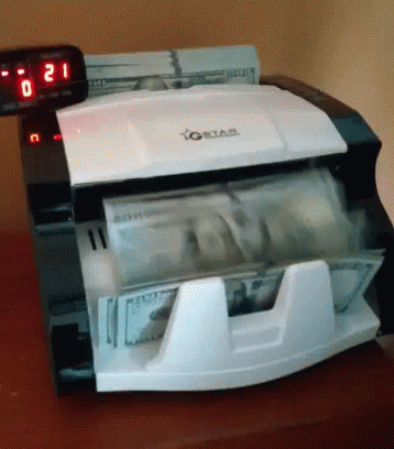 a money counting machine sitting on top of a counter