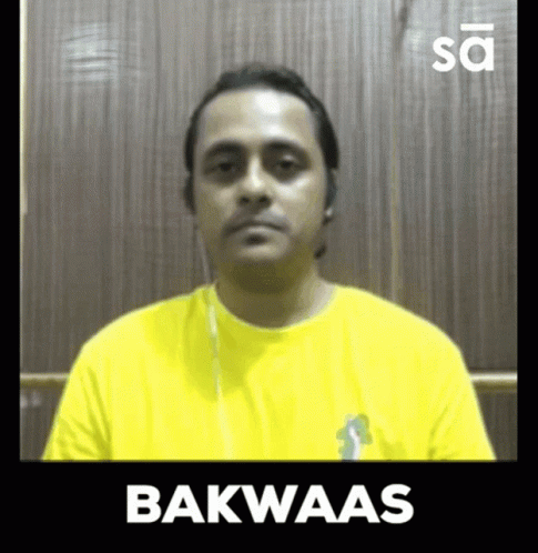 a man sitting down in front of a mirror with the text bakwaas on it