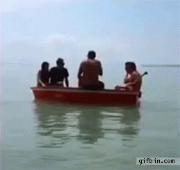 a group of people ride in a blue row boat