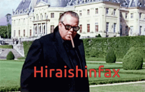 a man walking past large buildings with the words hiratshinfax