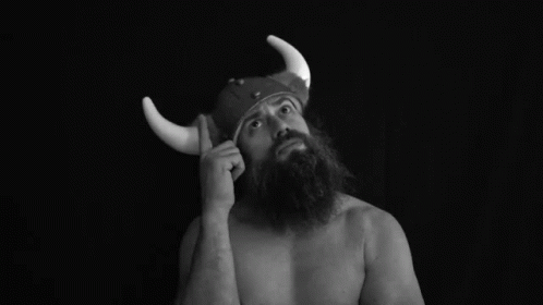 man with fake horns and a beard on cell phone