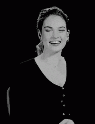 woman with a black background laughing