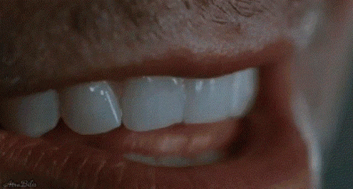 a person that has some teeth brushing their teeth