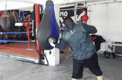 a man is practicing boxing in his garage