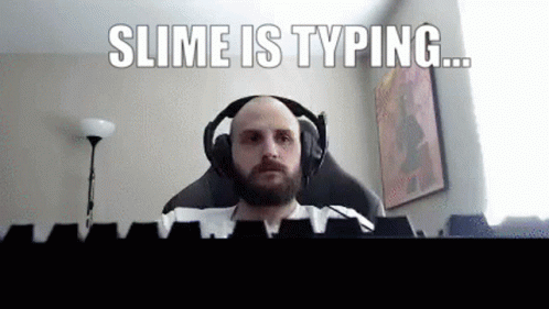 man with headphones on, staring at camera with the text slime is typing