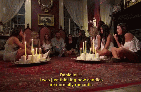 some women with candles on plates in a room