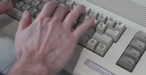 gloved hands are placed on the top of the keyboard