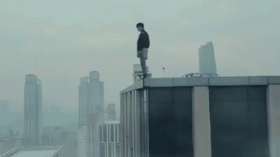 a person standing on top of a building looking down