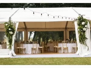 a white tent decorated with flowers and garlands