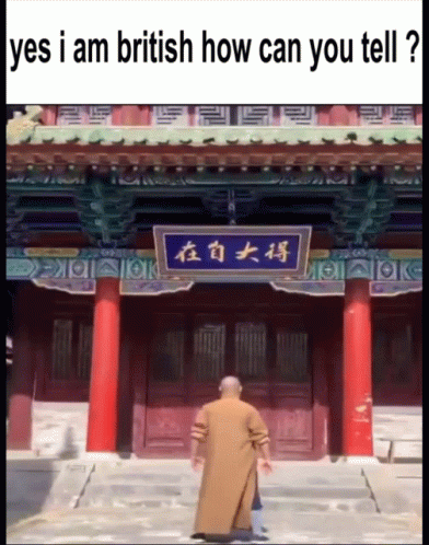 an old man in blue walking on steps at a chinese temple
