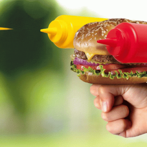 the hand of a person who is holding a hamburger toy
