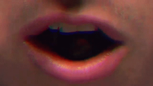 a close - up of the lip of someone with a blue blurry background