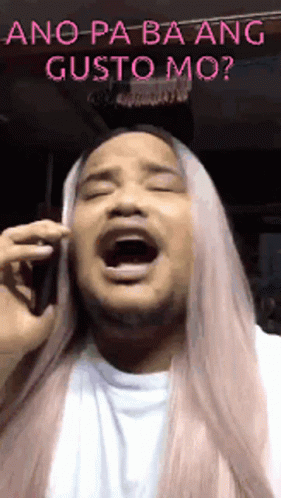 a blue man with long white hair is on a cell phone