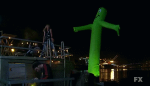 giant inflatable alien standing next to people