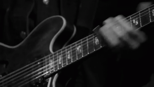 an electric guitar in a dark room with a blurry background