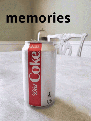 a can of soda with the words on it sitting in front of a table