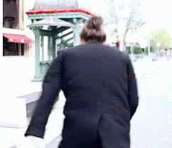 a man walking in a suit, with no pants