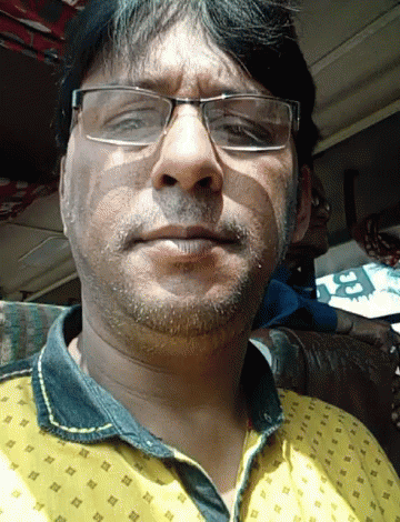a man with glasses is seen while taking a selfie