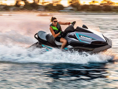 a man is riding on the back of a jet ski