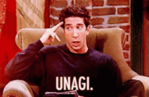 a man sitting on the couch wearing an unagi shirt