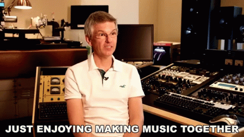 a person in front of music equipment with text that says just enjoying making music together