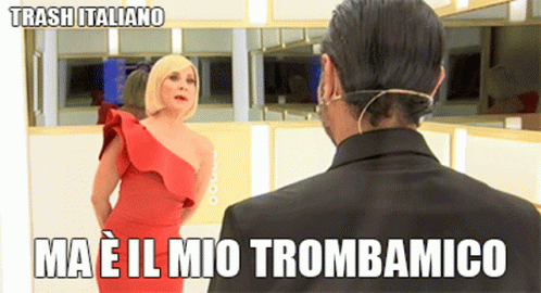 man looking at woman wearing blue dress and haircut with words that say, ma'el mio trombamico