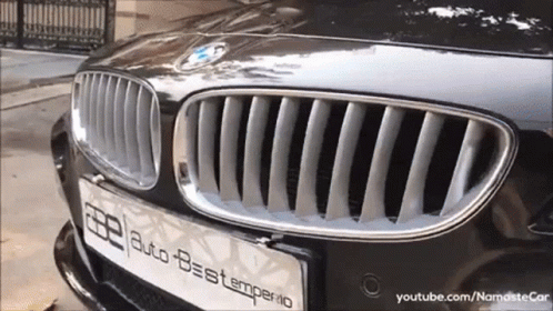 a shiny bmw is parked on a street