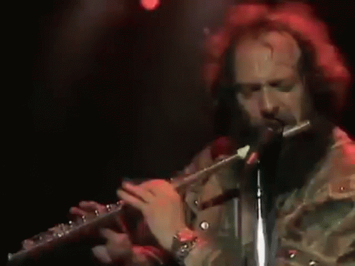 a man that is standing up with a flute
