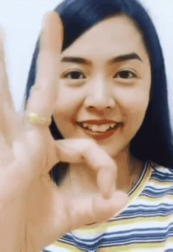 a girl making the v sign with her fingers
