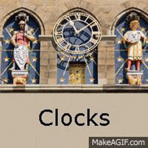 two statues of people in front of four clocks that spell it's 11 00 o'clock