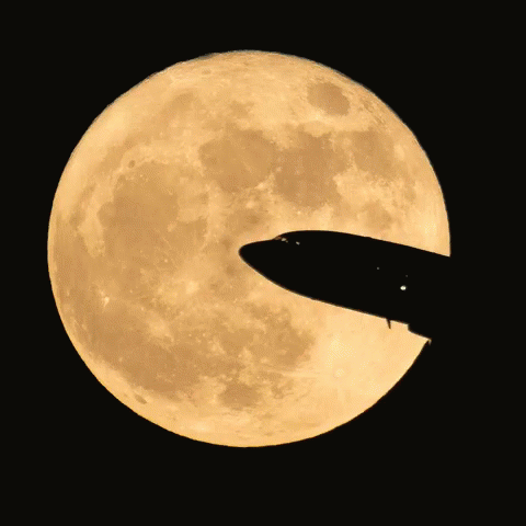 a jet plane flying across a blue full moon
