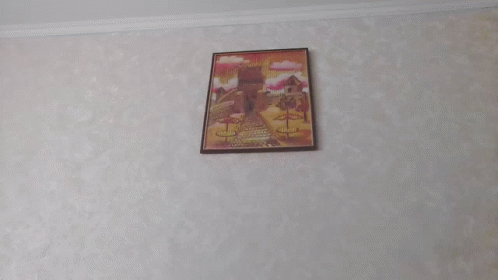 a painting hanging on the wall above a bed