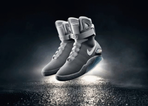 nike sneakers in mid air on a dark surface