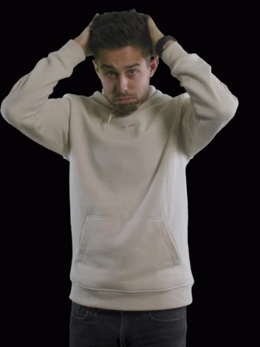 man covering his head with his hands while posing