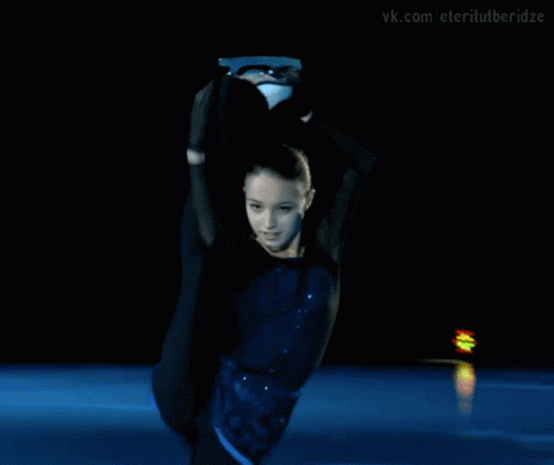 a young woman dressed in a dark colored dress practicing tricks