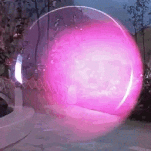 a big glass ball in the middle of a park