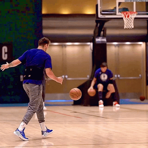 a man is playing with a basketball on a court