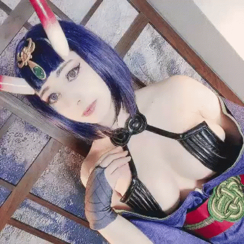 a woman wearing a bunny suit and mask with horns