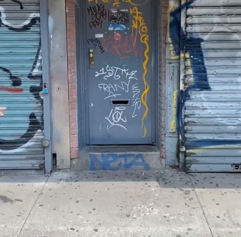 an open door with graffiti next to it